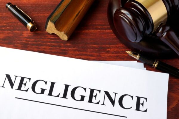 Negligence written on a white paper and Judge's gavel