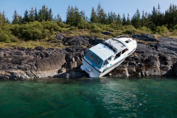 Accident at sea; photo of recreational boat on dry land after collision with rocks