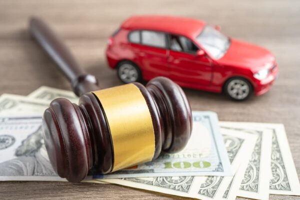 Hammer gavel judge and US dollar banknote money with car vehicle accident