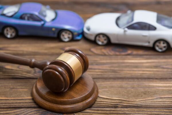 Collision between two cars and a gavel - concept of lawsuit and deposition