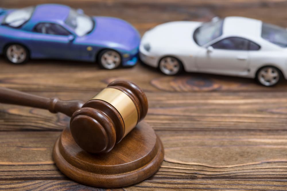 Collision between two cars and a gavel - concept of lawsuit and deposition